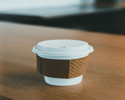 A warm cup of coffee on a wooden desk, symbolizing a friendly conversation